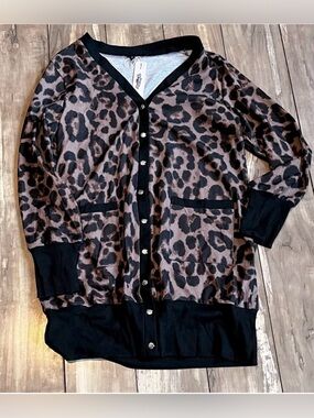 Styleworld leopard print cardigan sweater with black trim and pockets.